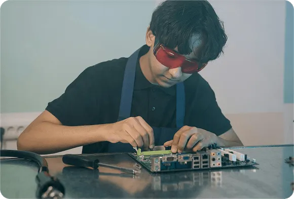 Student working on semiconductor hardware in a lab environment
